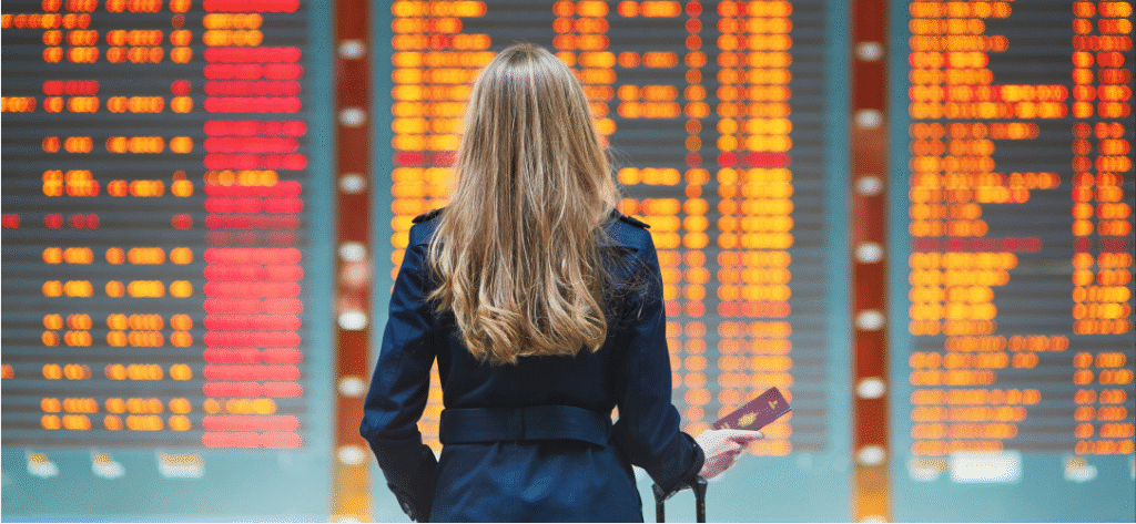 Woman looking at flight boards all cancelled to depict - The Hidden Costs... - Article Article Image - _Difficulty with Cancellations and Changes _